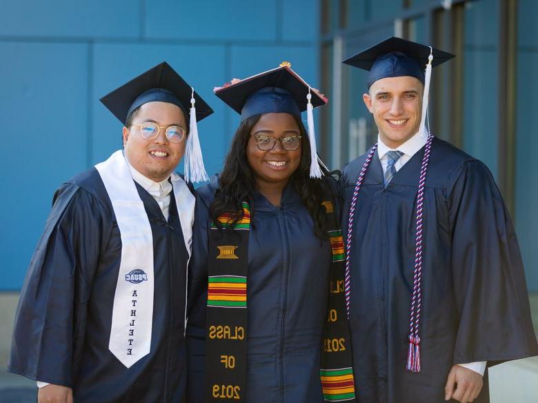 Students smiling after graduation.