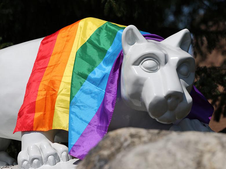 lion with colored flag draped over it